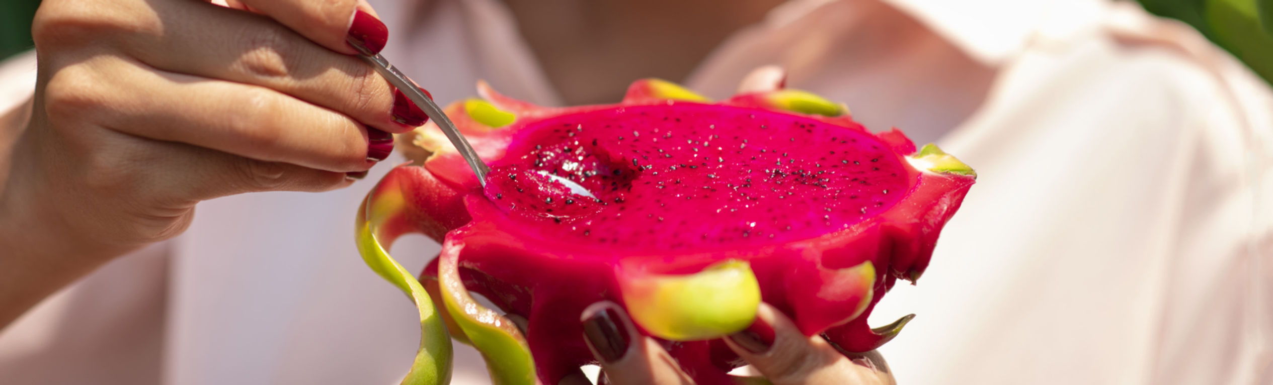 Holding a halved dragon fruit